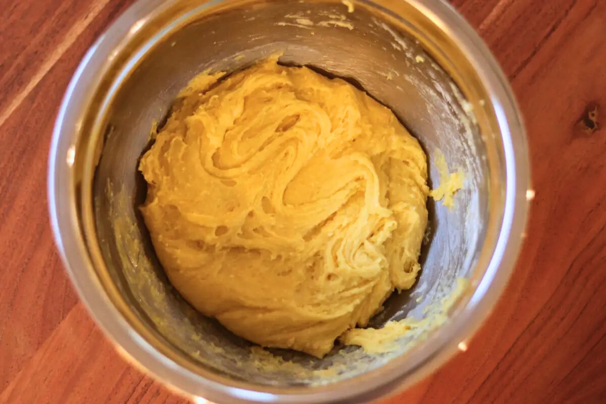 Dough for cake mix chocolate chip cookie bars in a mixing bowl.