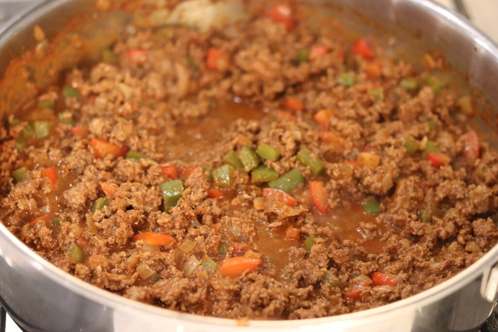 Slowly add the broth while the beef browns