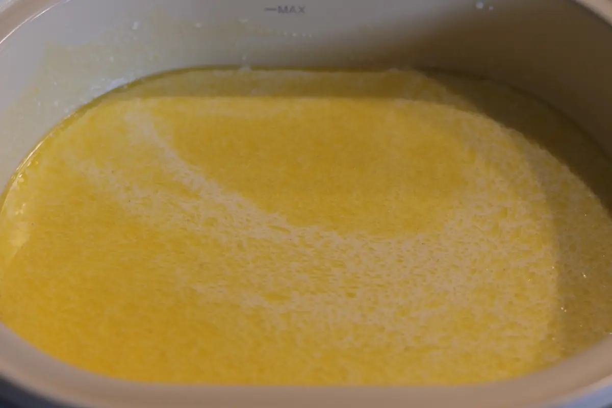 The crockpot filled with the cream and spices.