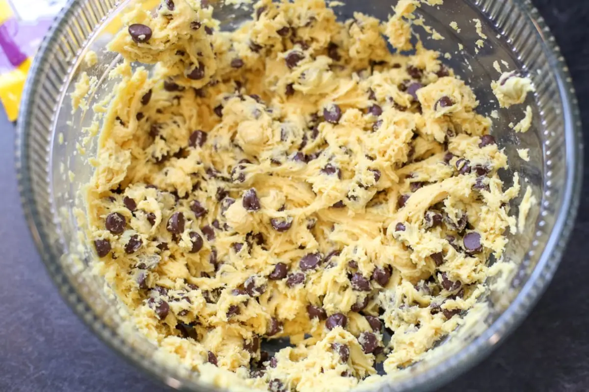 Cookie dough for cake mix chocolate chip cookies in a mixing bowl.