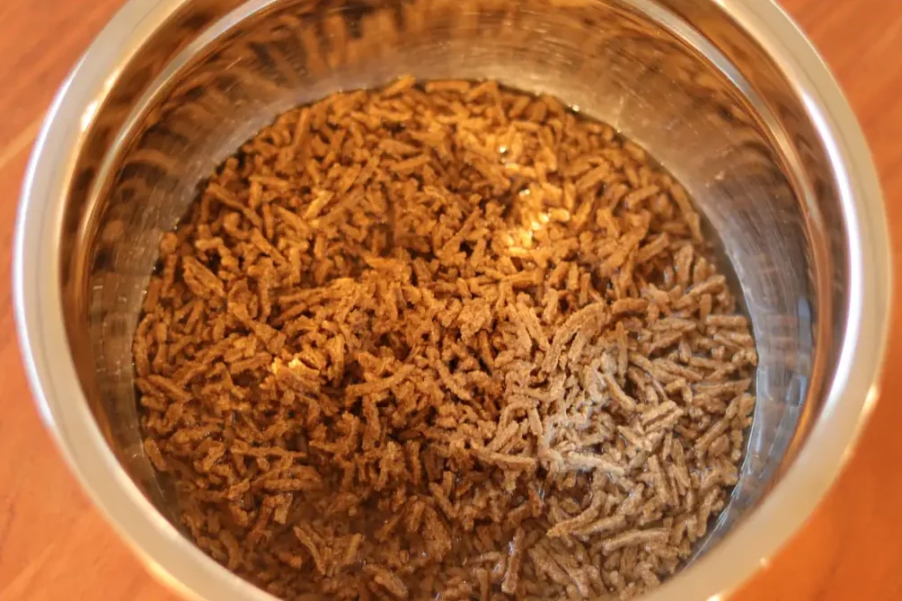All-bran cereal in a mixing bowl, soaked in water.