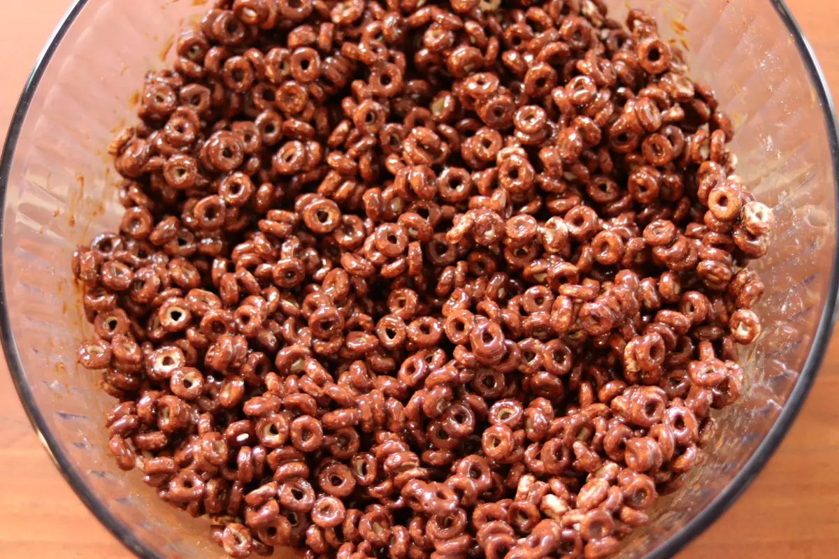 a large bowl of cheerios coated in the chocolate/peanut butter mixture. 