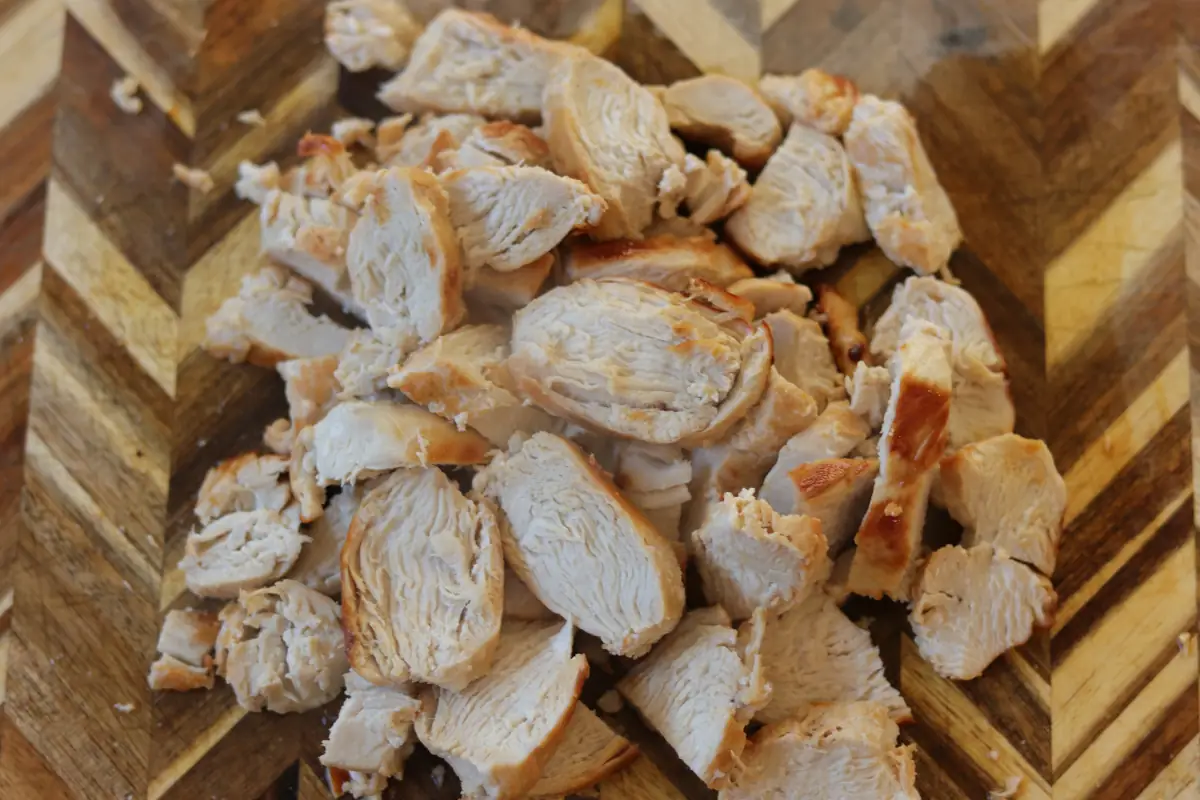 Cubed chicken on a cutting board. 