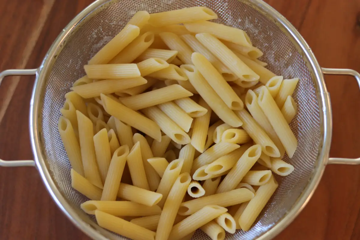 Cooked pasta in a colander. 