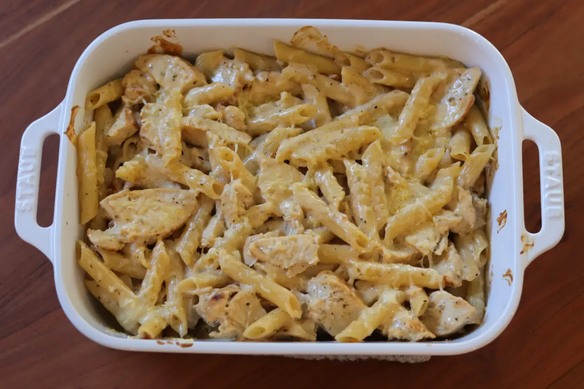 Baked chicken alfredo in a white dish.