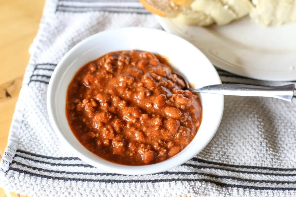 Bowl of 4 ingredient chili on a striped towel.