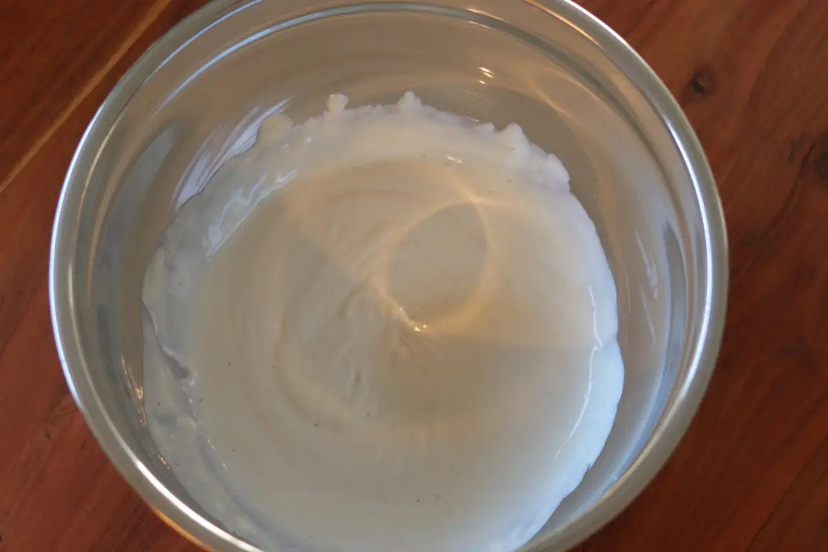 Greek yogurt, alfredo sauce, and ranch seasoning in a bowl.