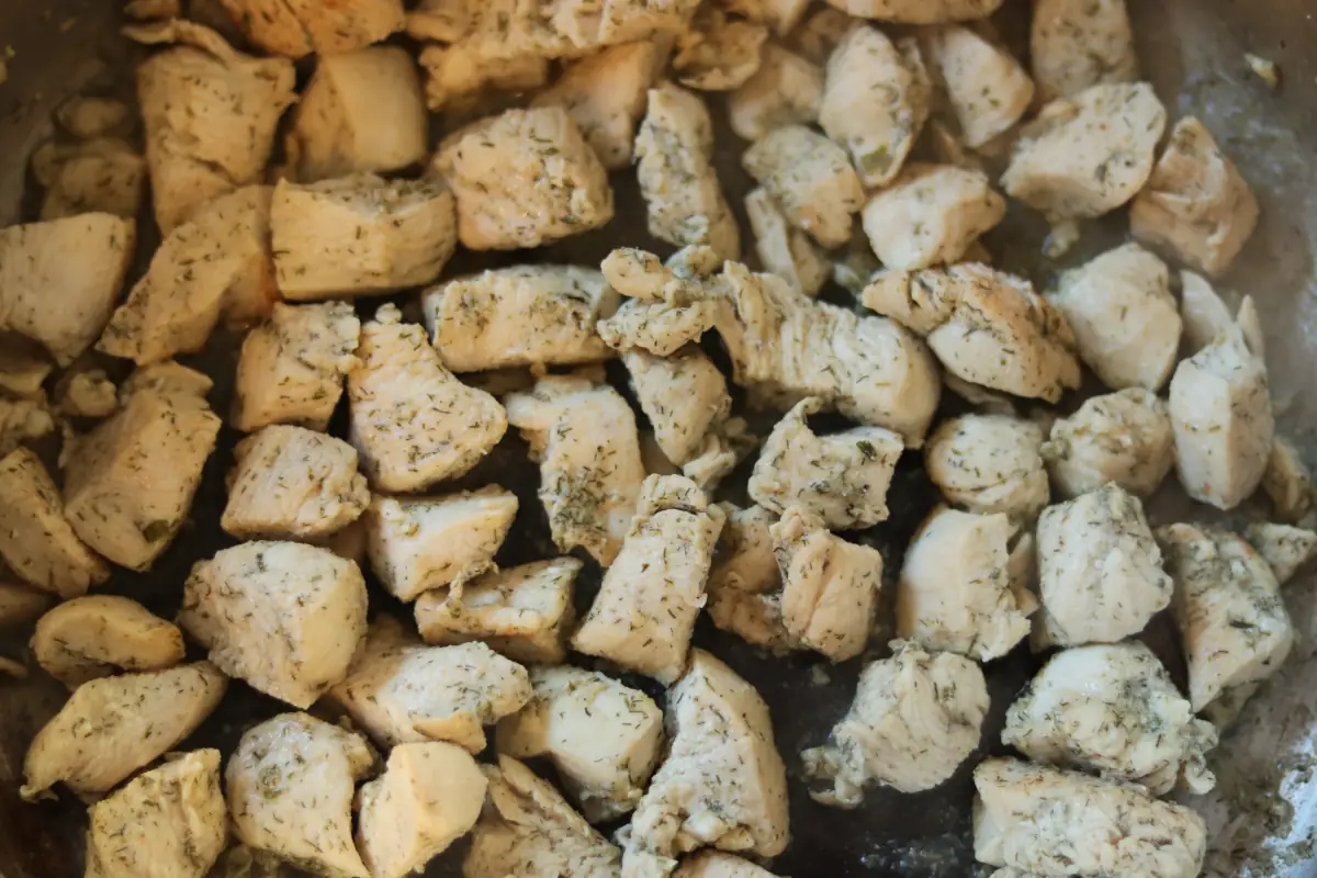 Chicken breast cut into cubes that has been cooked.