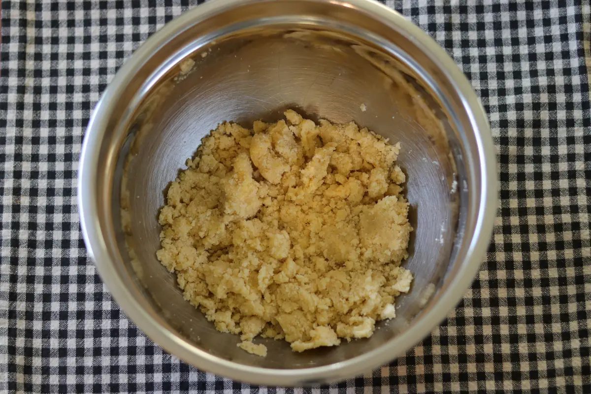 Softened butter incorporated into dry ingredients.