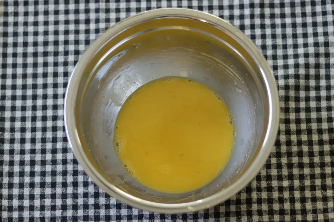 Wet ingredients for lemon brownies in a mixing bowl.