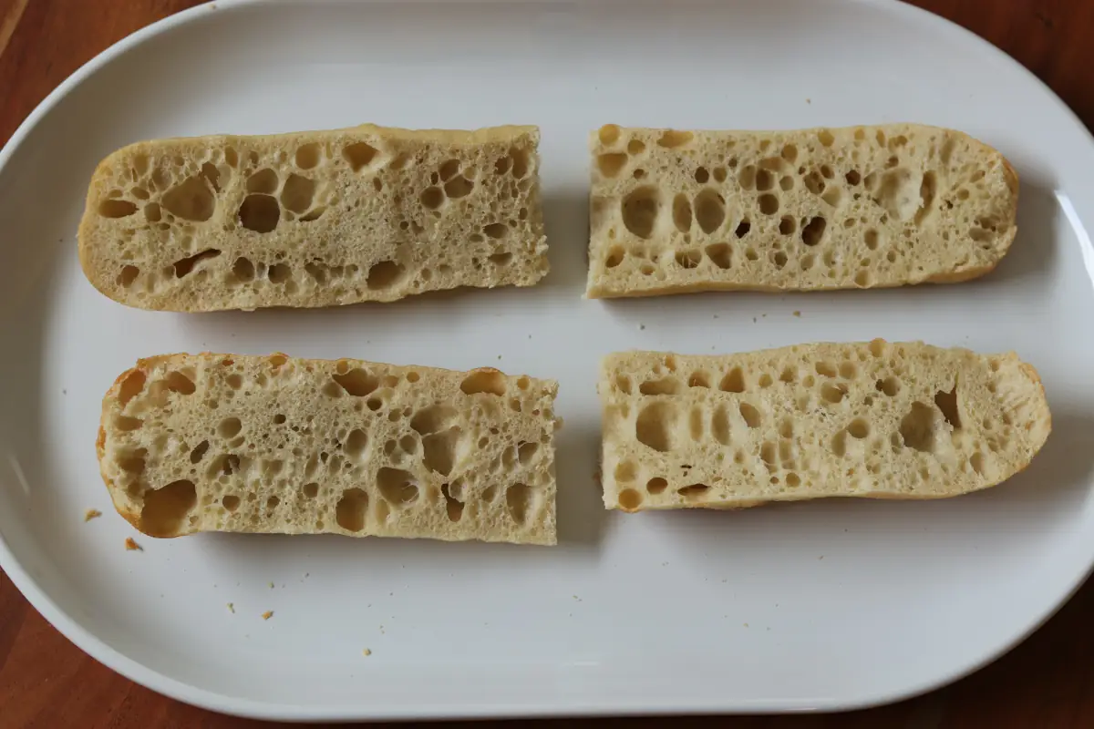 4 slices of french bread on a white platter.