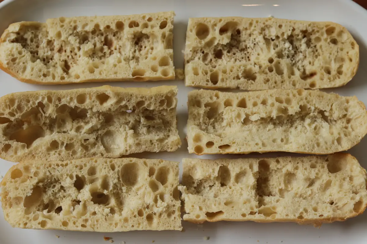 Slightly hollowed out french bread on a platter.