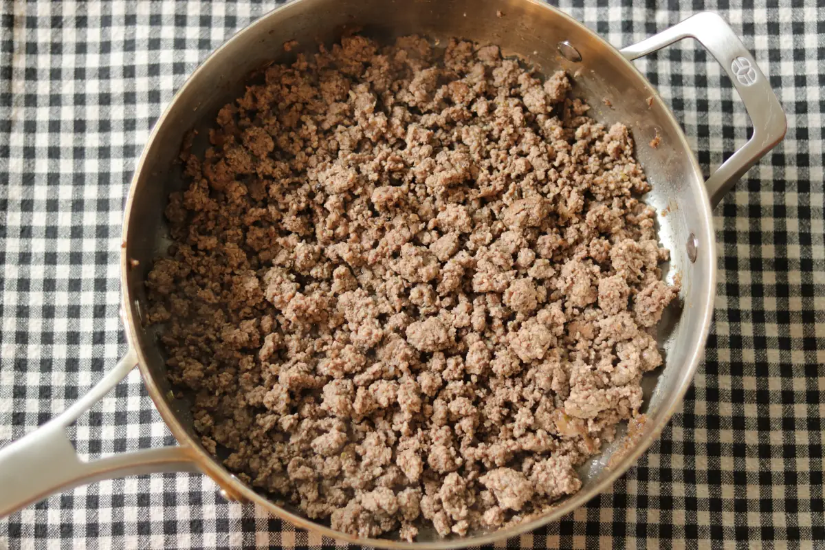 Ground beef browned in a skillet.