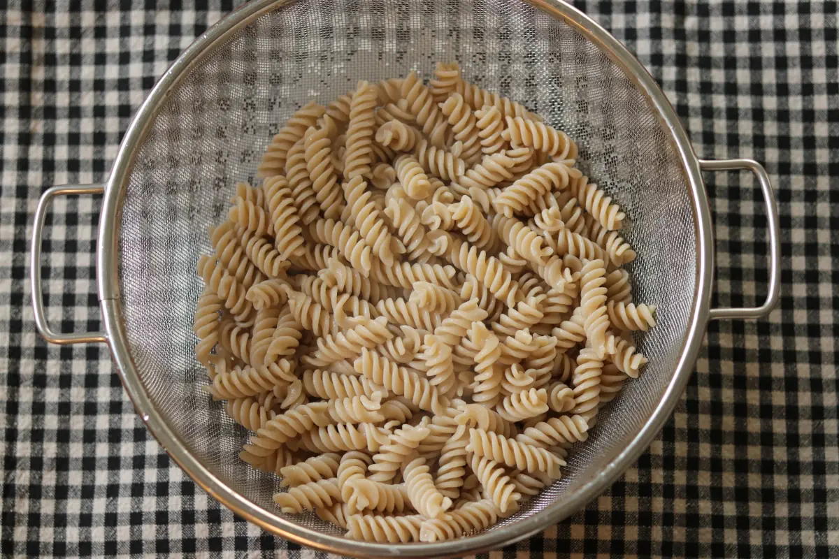 Cooked pasta in a colander.