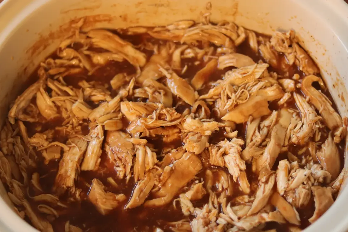 Chicken shredded in the slow cooker.