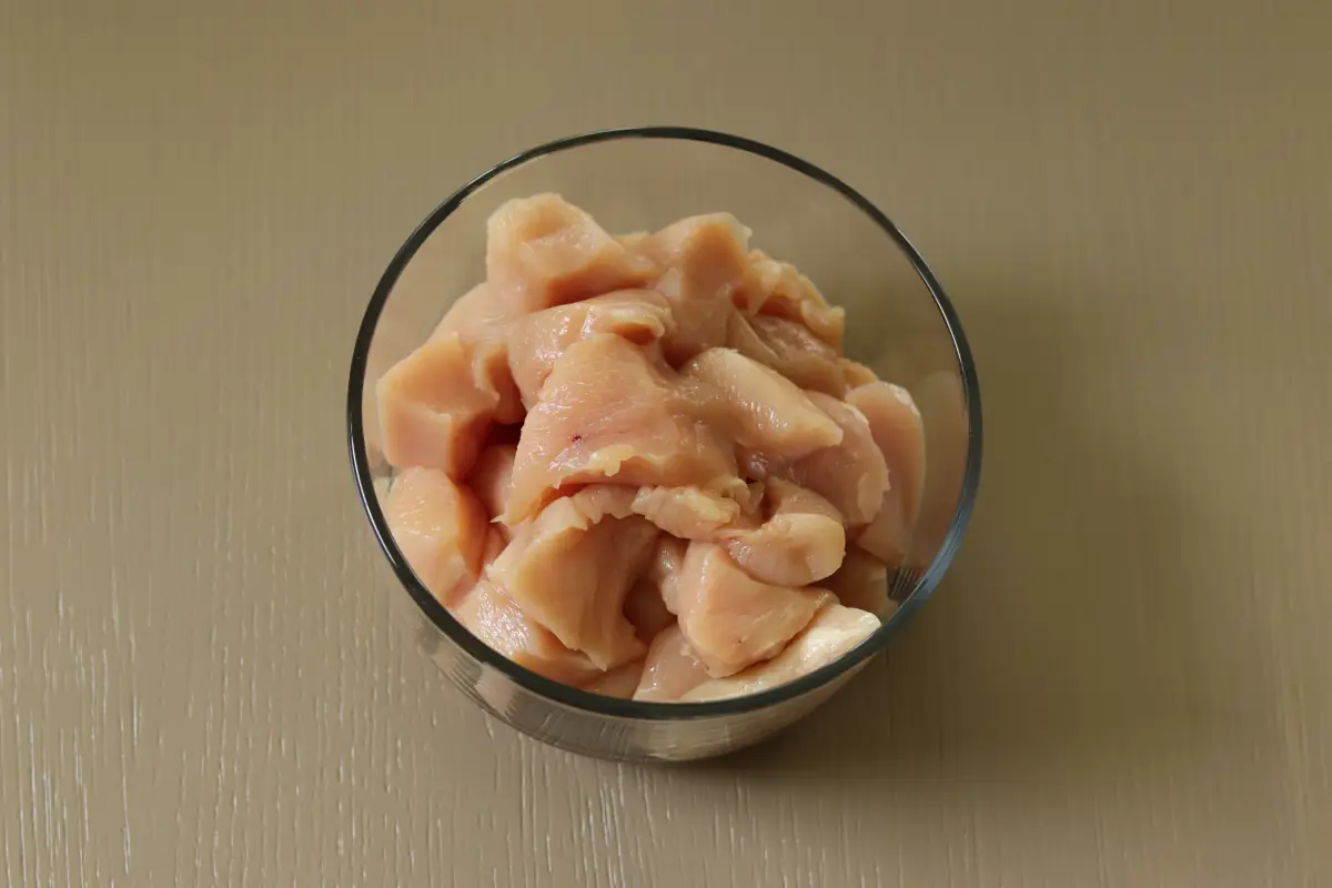 Cubed chicken breast in a bowl.