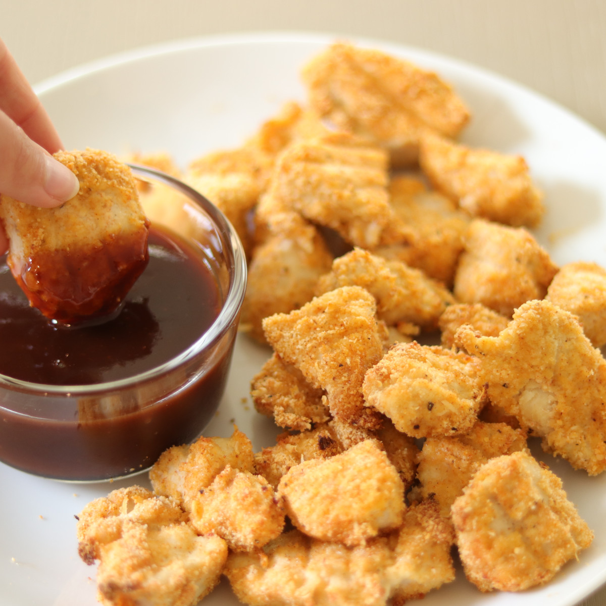 Gluten free chicken nuggets dipped in dipping sauce.