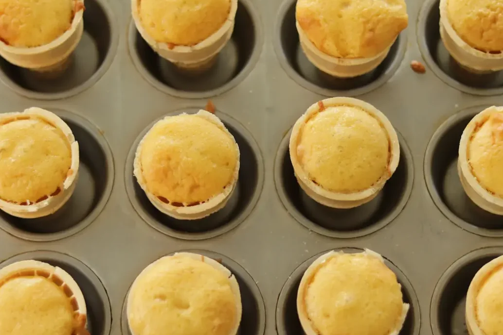 Cake batter in the ice cream cones after it has been baked.