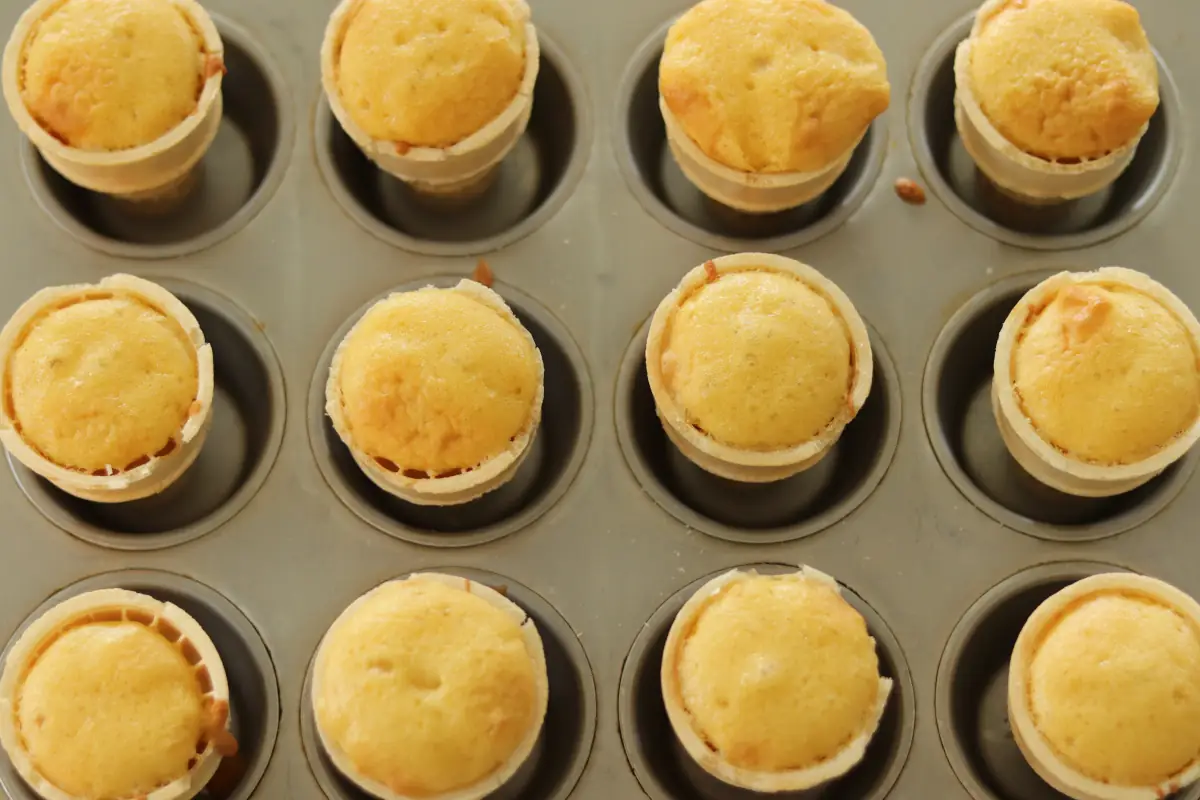 Cake batter in the ice cream cones after it has been baked.