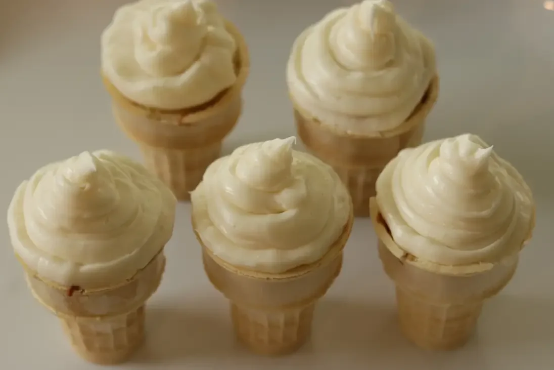 Ice cream cone cupcakes that have been frosted.