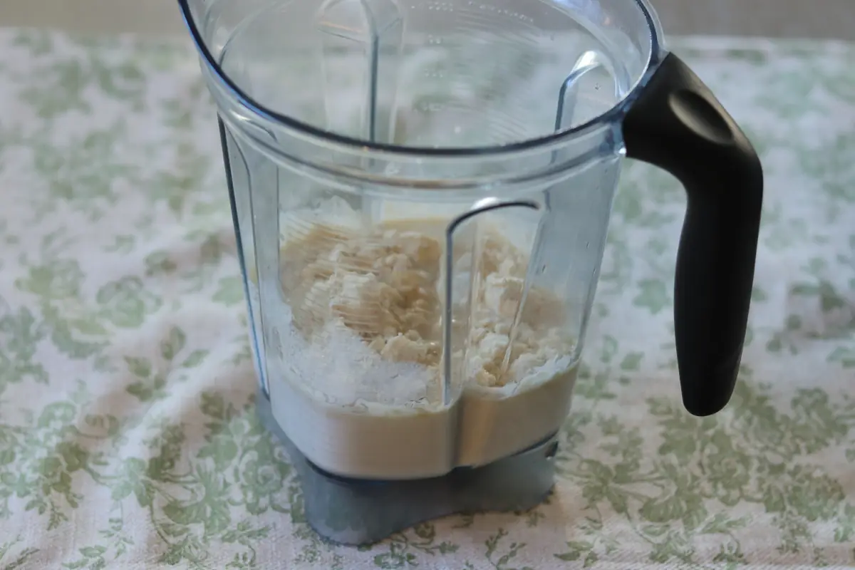 Ingredients for the ninja creami ice cream added to a blender.