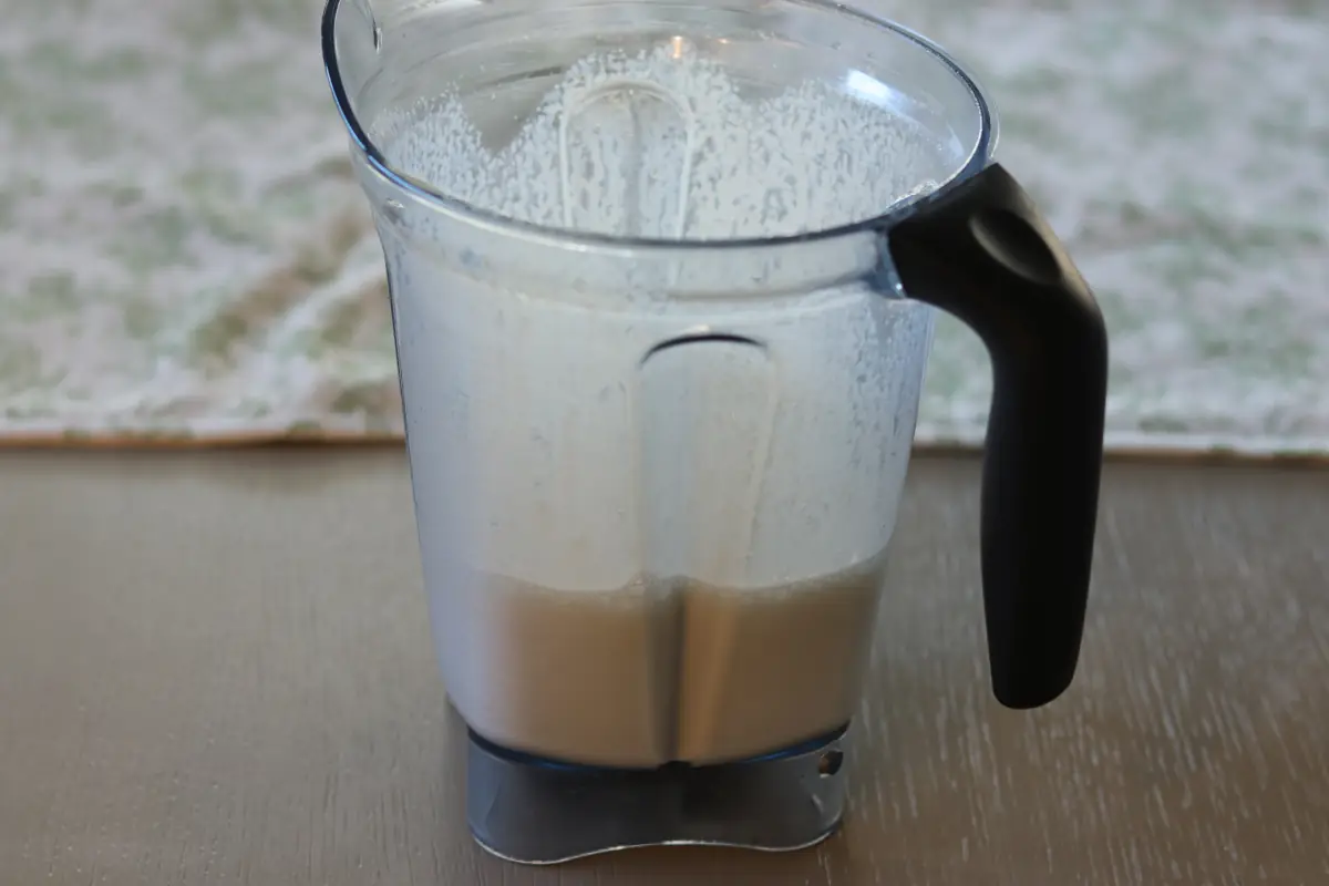 Ingredients for the ninja creami ice cream blended in a blender.