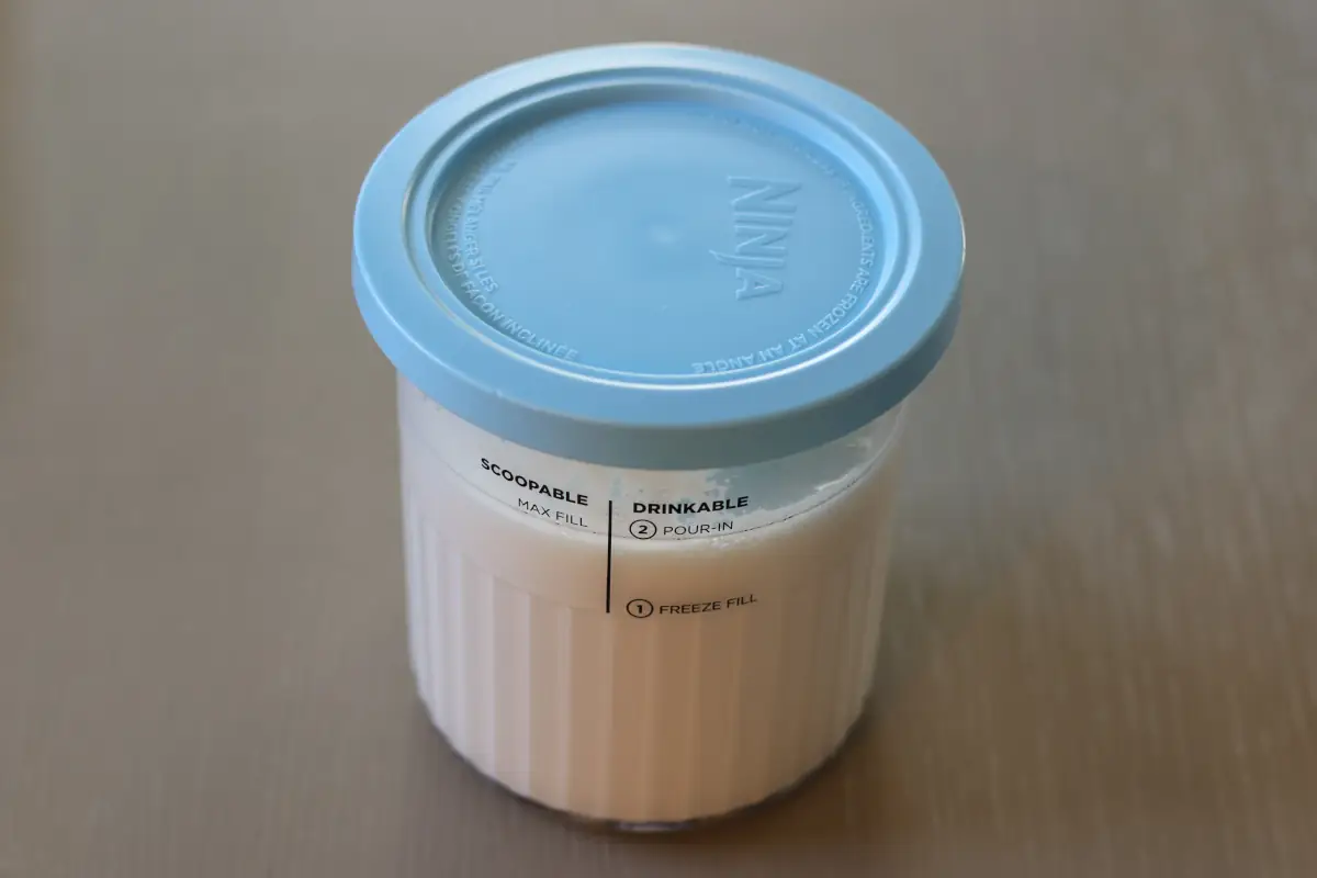 Ninja creami mixture in the container with a lid on.