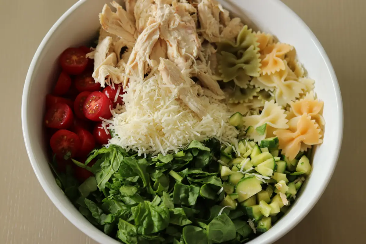 All the ingredients for the chicken pasta salad in a bowl.
