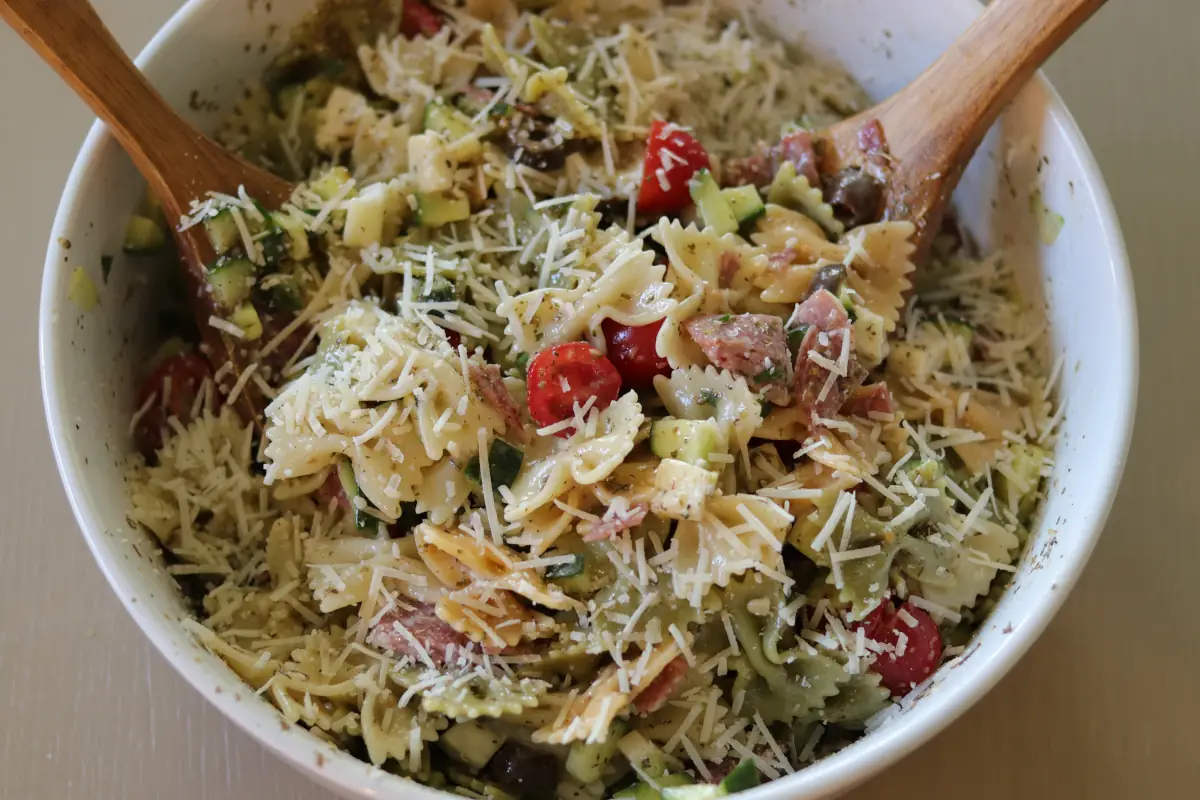 zesty italian pasta salad prepared in a white serving bowl.